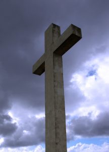 Cross against cloudy sky